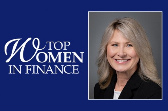 A woman smiles next to a